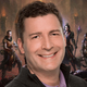 Mike Ybarra smiles at the camera with Diablo warriors behind him in the background.